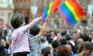 Child waving flag at LGBT friendly event