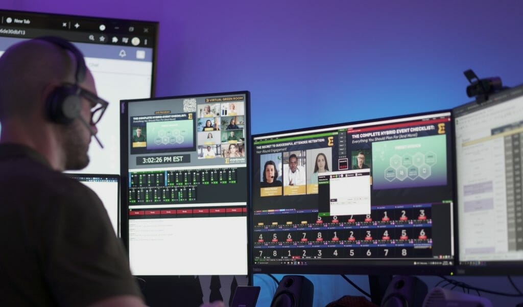 Professional managing multi-screen video production and streaming studio setup