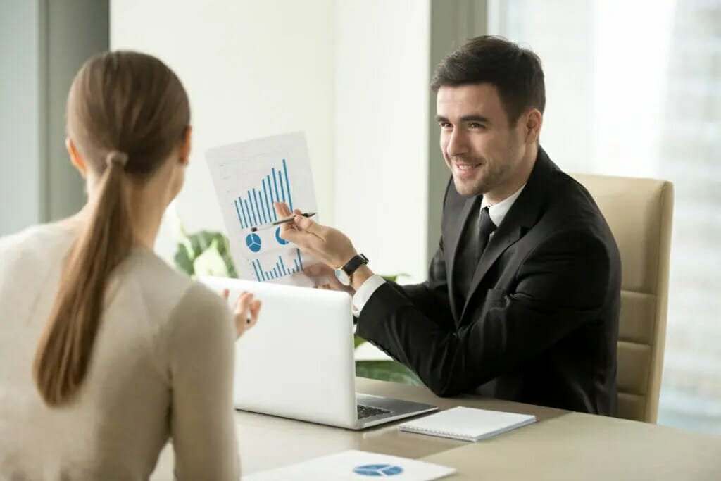 Happy project manager holds financial report, shows rising stats and growing graphs to colleague, satisfied with great development rate, successful strategy, business growth, company success concept