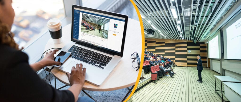 Image depicting a hybrid event: On the right a man is speaking in front of an audience and on the left a woman watches a live stream of the conference on a laptop.